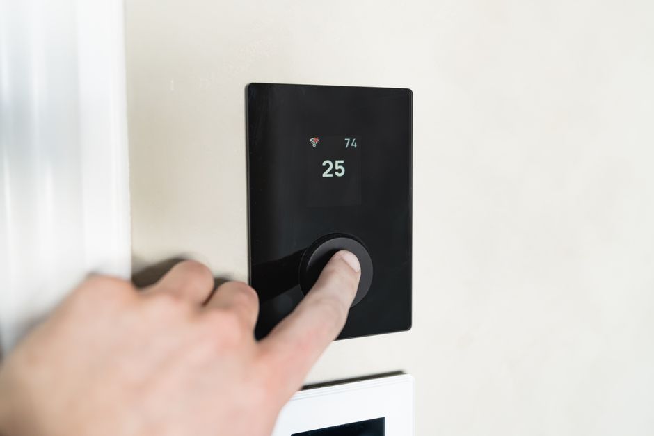 Person using a smart energy app on a tablet to monitor solar power usage
